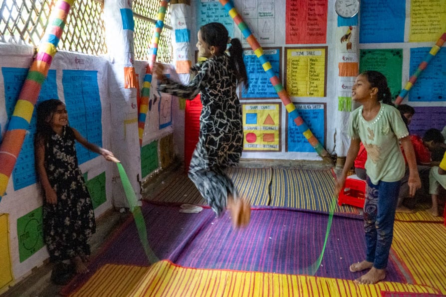 A girls jumps over a skipping rope at a learning center in Kutupalong Refugee Camp, Bangladesh.