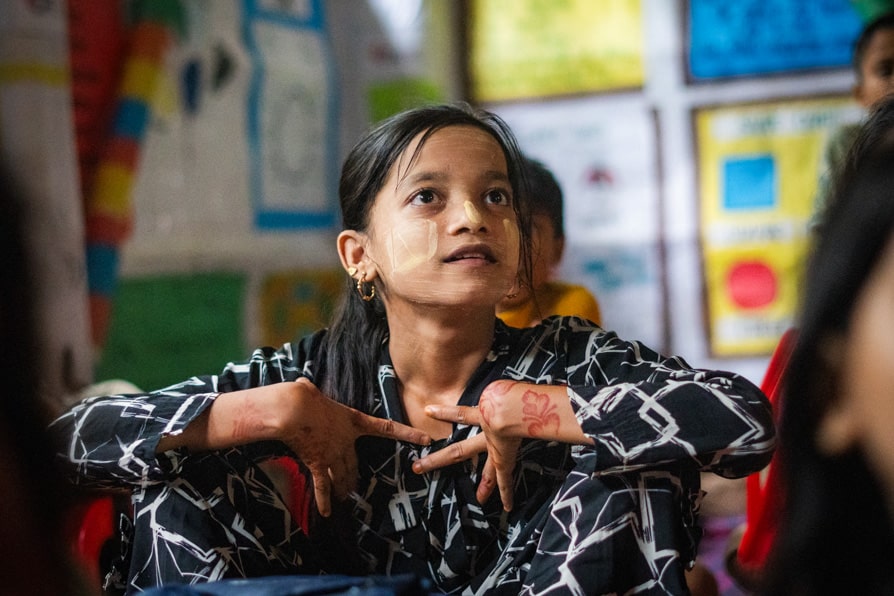 A girls sits during a lesson at a learning center in Kutupalong Refugee Camp.