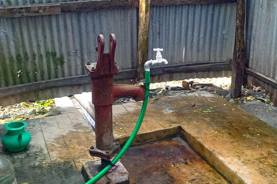 A pipe and tap connected to a safe water network in Kalishakhali village, Bangladesh, attached to the nozzle of a broken well pump.