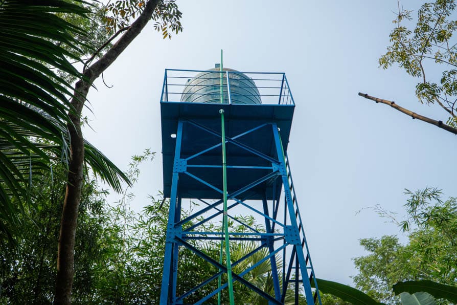 A high-capacity water tank raised on a metal frame that forms part of a safe water network in Kalishakhali village, Bangladesh.