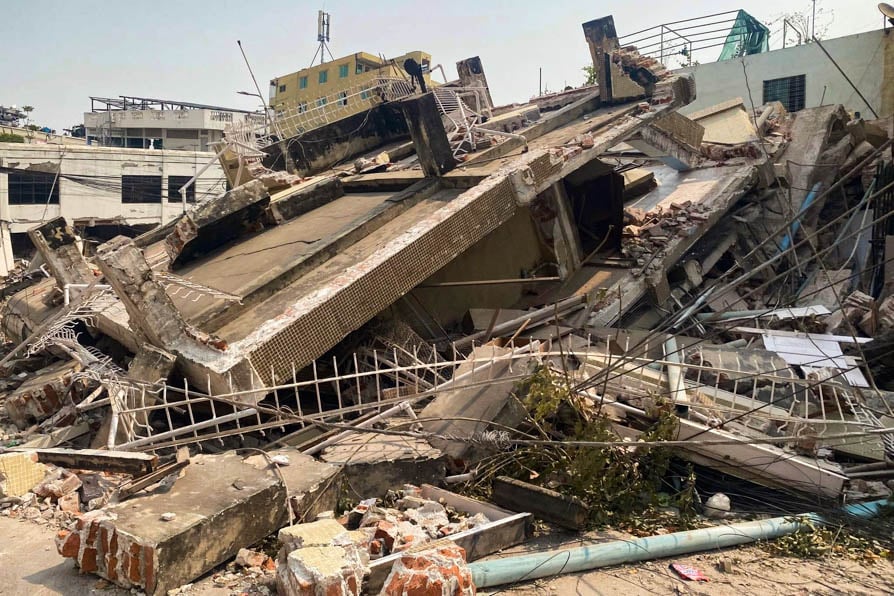 The remains of a building, surrounded by debris, that collapsed during the March 2025 earthquake in Myanmar.