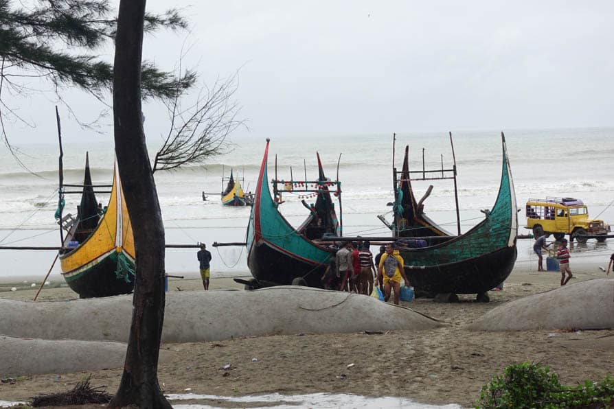 Boats sit on the sand on the shoreline in Cox's Bazar, Bangladesh.