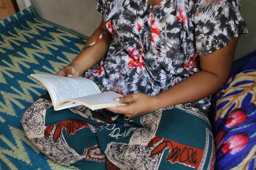 A woman reads a book at a maternity waiting home in southeastern Myanmar.