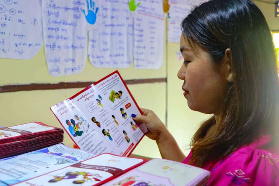 A woman looks at an information leaflet at a safe space for women and girls in southeastern Myanmar.