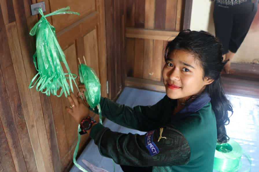 A woman participates in a weaving class at a safe space for women and girls in southeastern Myanmar.