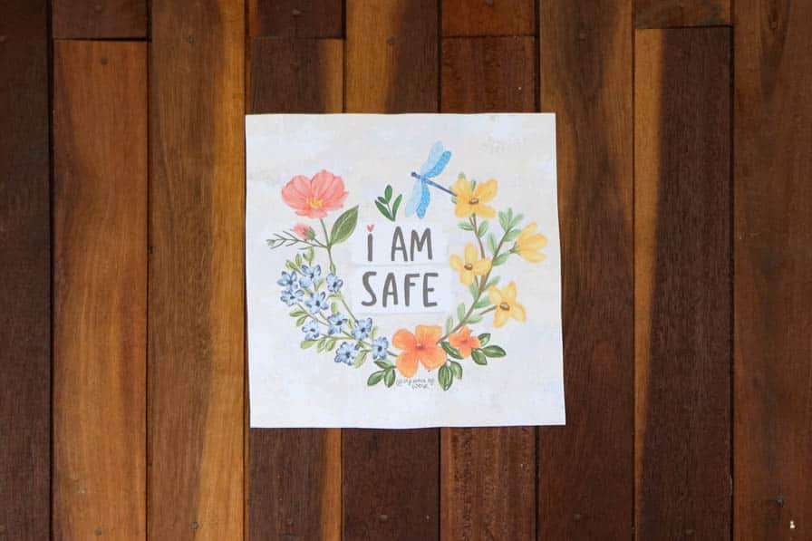 A poster reading "I am safe" and illustrated with flowers on the wall of a safe space for women and girls in southeastern Myanmar.
