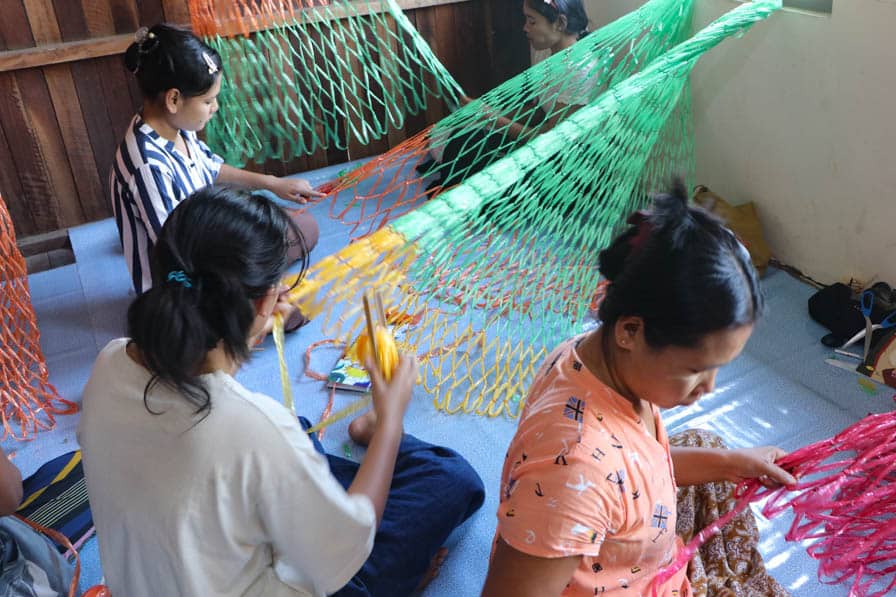 Women participate in a weaving class at a safe space for women and girls in southeastern Myanmar.
