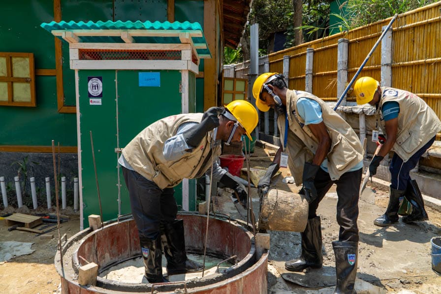 Rohingya WASH workers make concrete rings for toilet cesspits in Kutupalong Refugee Camp, Bangladesh.