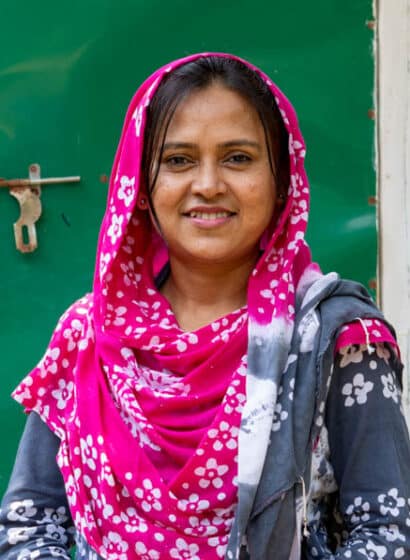 Naznin, a hygiene promotion officer, stands in front of a toilet block that incorporates a menstrual hygiene management chamber in Kutupalong Refugee Camp, Bangladesh.