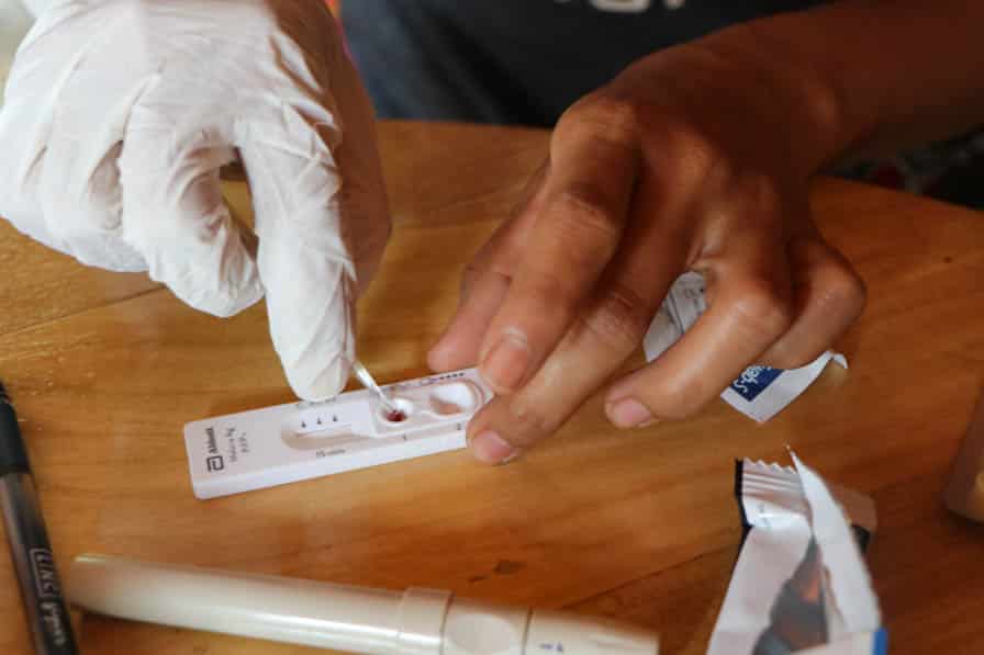 A community volunteer conducts a malaria rapid diagnostic test in southeastern Myanmar.
