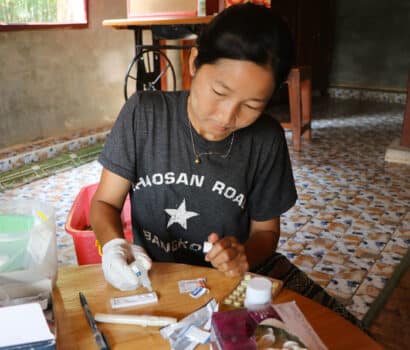 A community volunteer conducts a malaria rapid test in southeastern Myanmar.