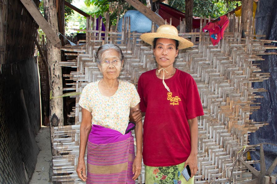 Handloom weaver Ma Marlar Oo stands with her mother outside her house in Amarapura, Myanmar.