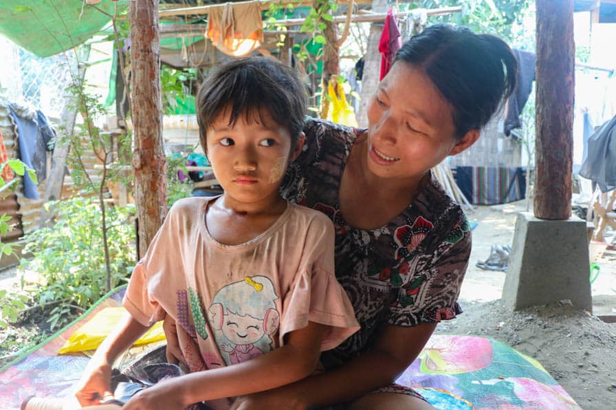 Ma Myint Thwe sits with her daughter on her lap in Amarapura, Myanmar.