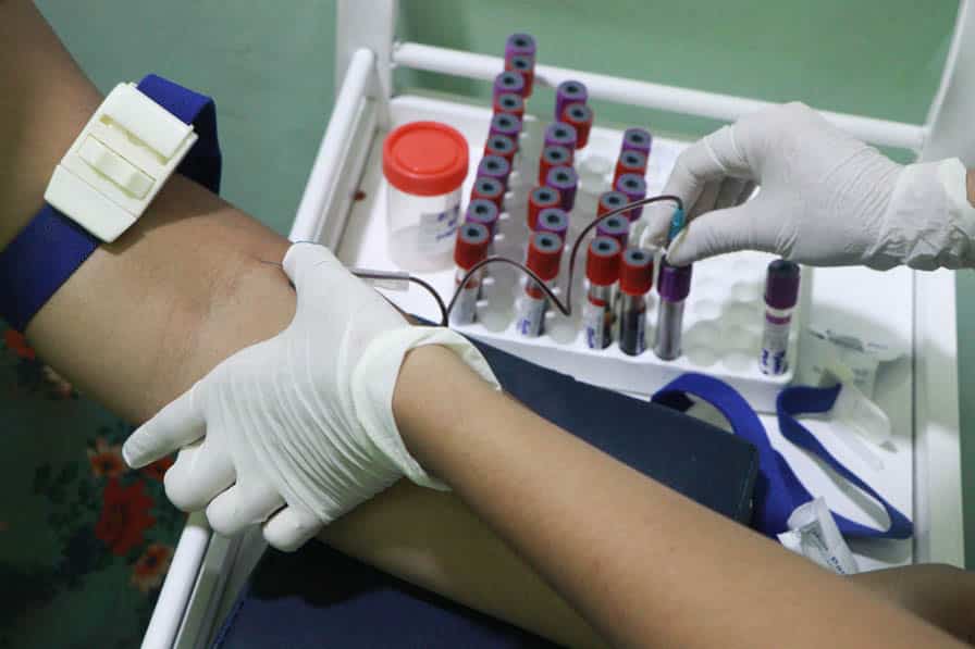 A health worker takes blood from a patient at the Nae Thit Kyan Mar clinic in Amarapura, Myanmar.