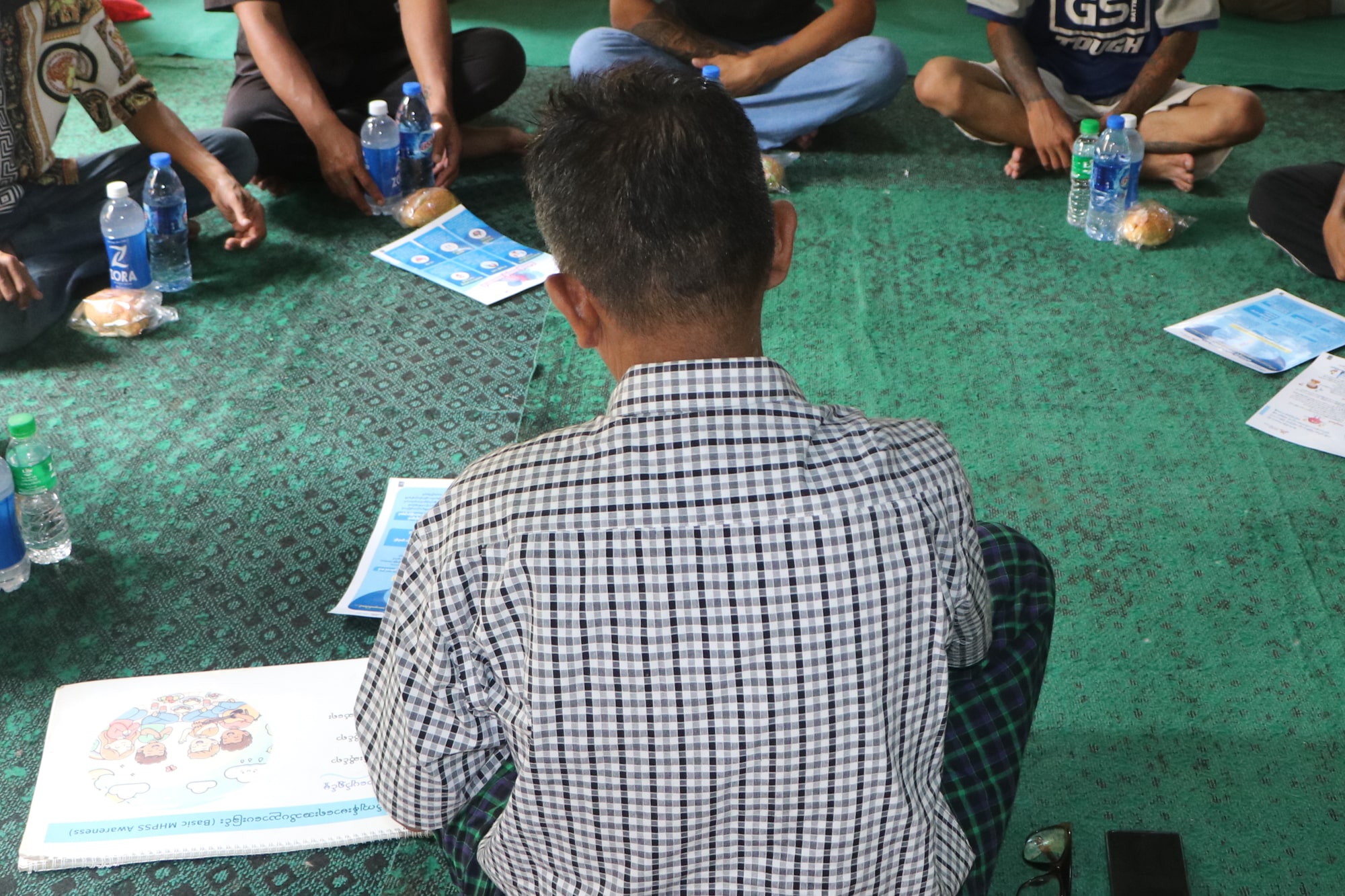 A deaf counselor and deaf survivors of the March 2025 earthquake sit in a circle during a mental health counseling session in Mandalay, Myanmar.