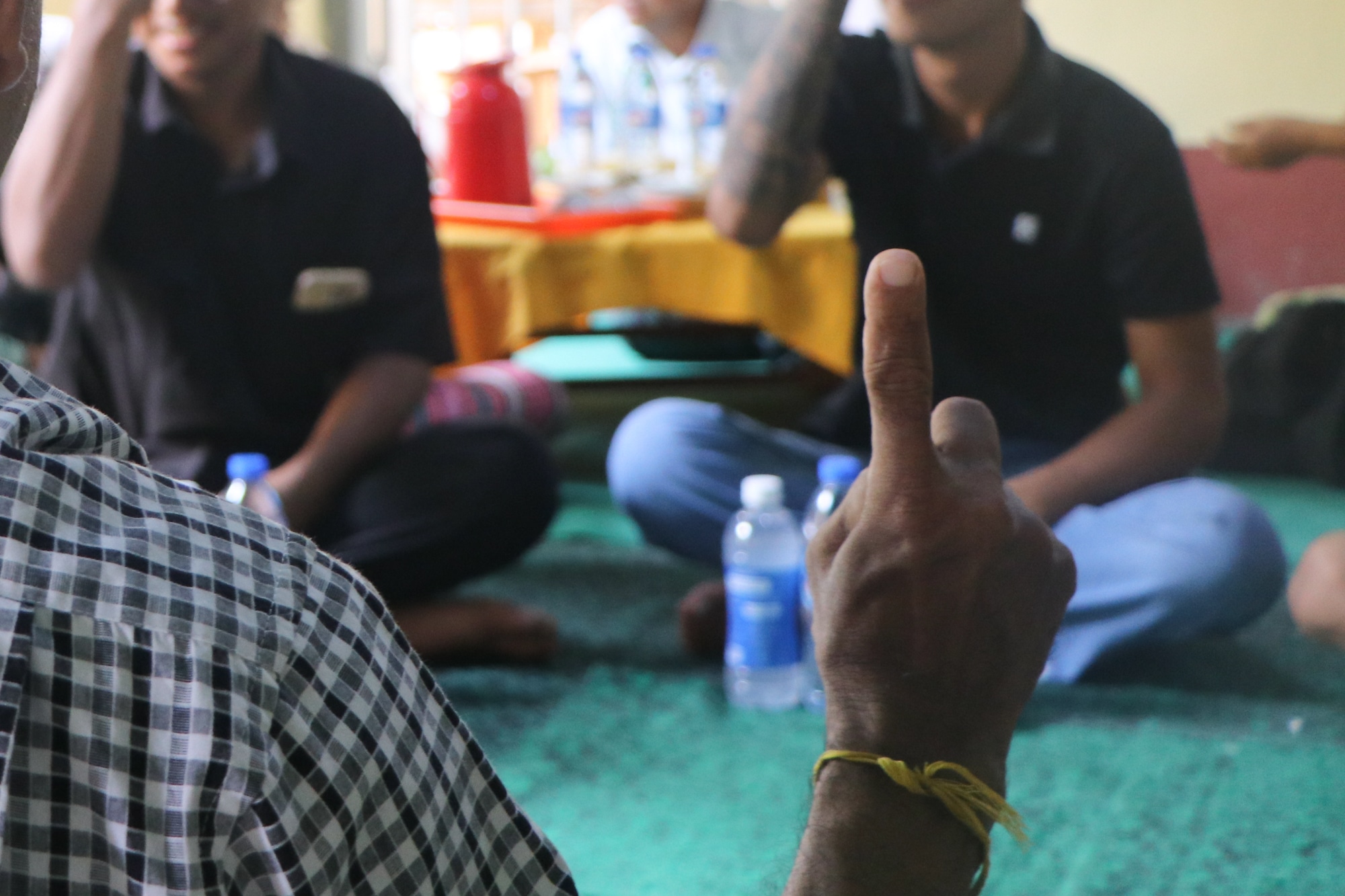 A deaf counselor holds up a finger while signing during a mental health counseling session for deaf survivors of the March 2025 earthquake in Mandalay, Myanmar.